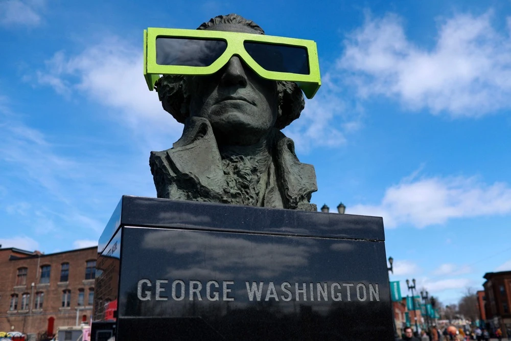 Eclipse glasses are worn by a statue of George Washington on April 07, 2024, in Houlton, Maine, US.