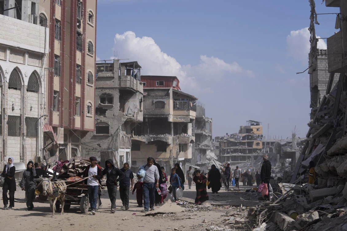 Palestinians walk through the destruction in the wake of an Israeli air and ground offensive in Khan Younis, southern Gaza Strip, Monday, April 8, 2024. Israel says it has withdrawn its last ground troops from the city, ending a four-month operation. (AP)