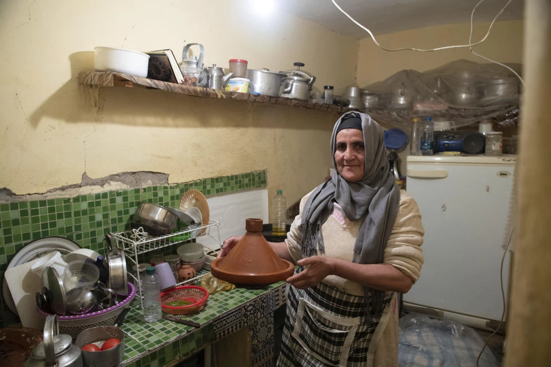 Fatima Barri, 57, prepares food to break her Ramadan fast in her home which was damaged by the earthquake last year, in Amizmiz, near Marrakech, on Apr. 4, 2024. (AP)