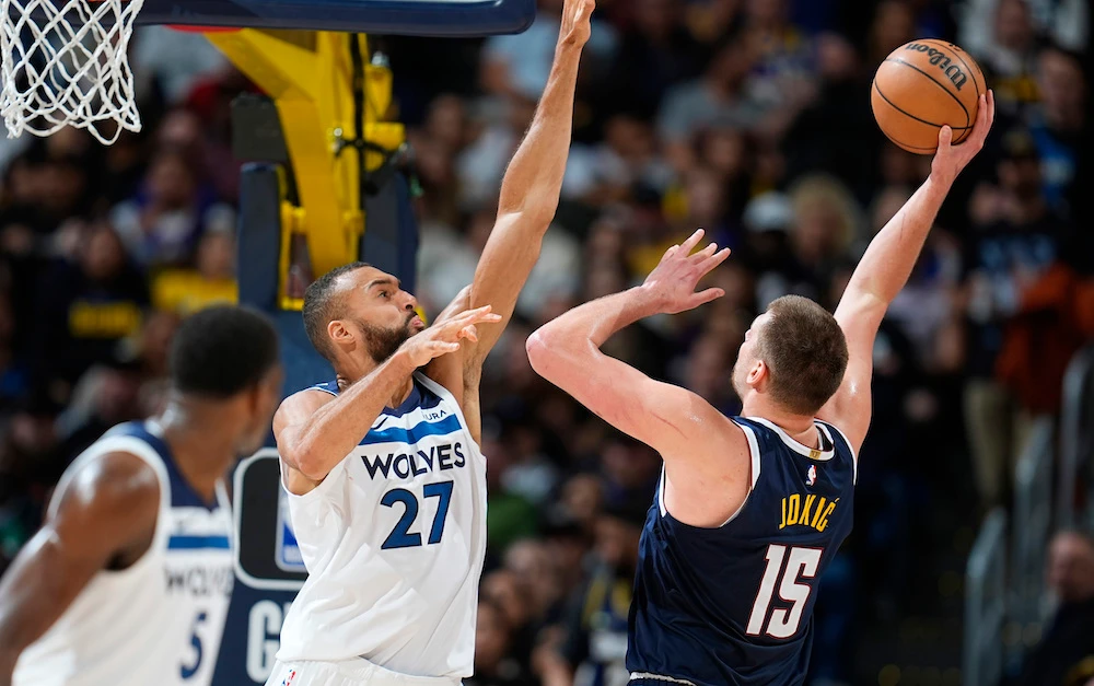 Denver Nuggets center Nikola Jokic, right, shoots against Minnesota Timberwolves center Rudy Gobert in the second half of an NBA basketball game Wednesday in Denver. (AP)