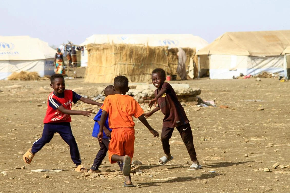 Displaced Sudanese children play near tents at a camp in southern Gadaref state for people who fled Khartoum and Jazira states, in war-torn Sudan, on Mar. 20, 2024. (AFP/File)