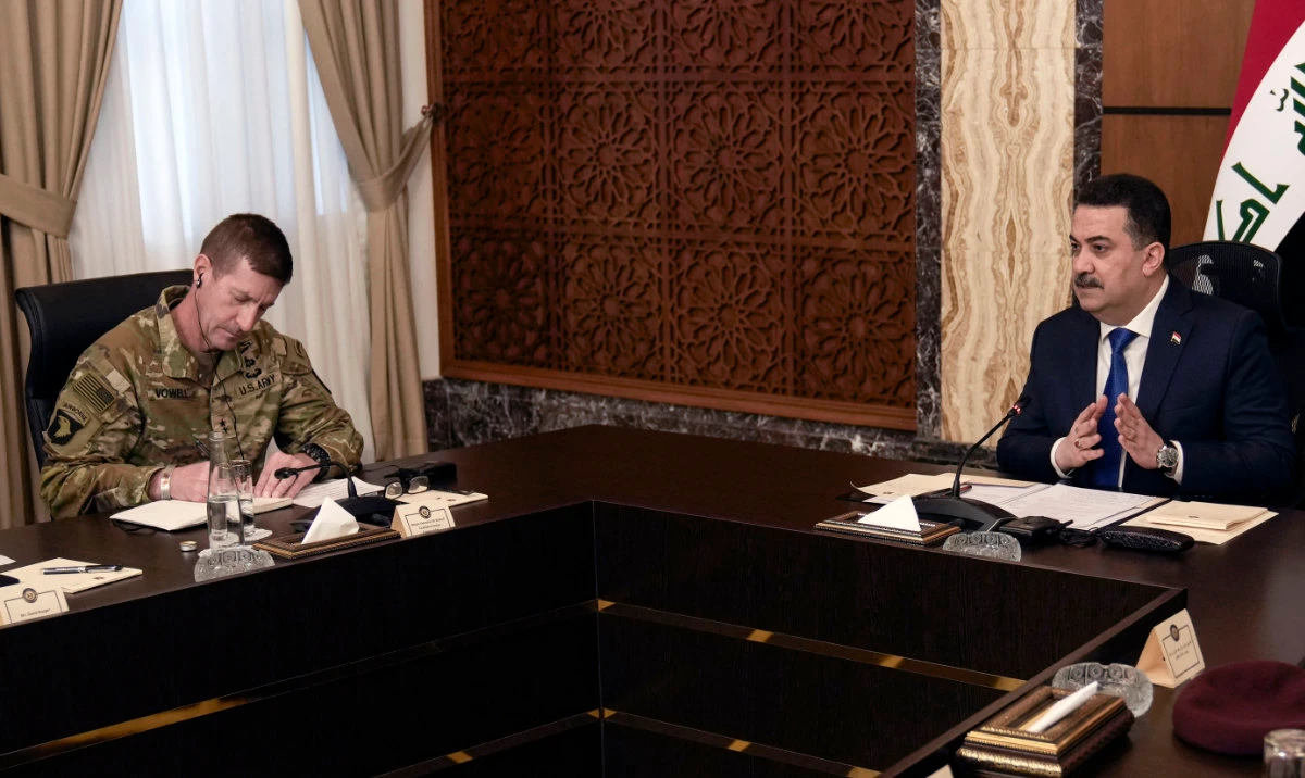 Iraqi Prime Minister Mohammed Shia Al-Sudani (R) speaks next to US Major General Joel “J.B.” Vowell during a meeting with top-ranking officials of the Iraqi armed forces and of the US-led coalition as part of the first round of talks on the future of American and other foreign troops in the country, in Baghdad, on January 27, 2024. (AFP)