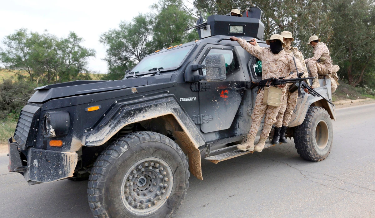 Members of the Tripoli Protection Force, an alliance of militias from the capital city, patrol an area south of the Libyan capital on January 18, 2019, during clashes with the Seventh Brigade group from the town of Tarhuna. (AFP)