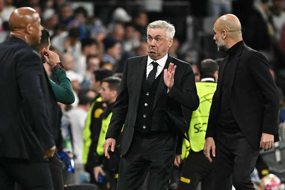 Real Madrid’s coach Carlo Ancelotti gestures next to Manchester City’s manager Pep Guardiola, right, during the UEFA Champions League quarterfinal first leg between Real Madrid and Manchester City in Madrid on April 9, 2024. (AFP)