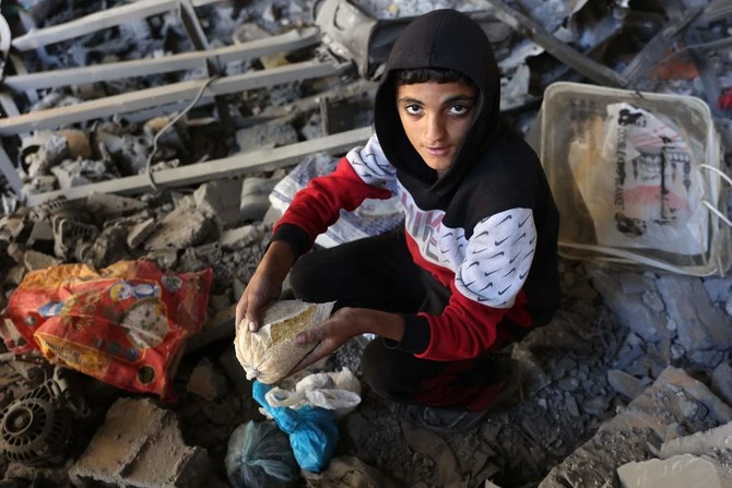 A Palestinian boy inspects the damage to the home of the Tabatibi family after Israeli bombardment in the Daraj Neighbourhood of Gaza on April 12, 2024, during the ongoing battles between Israel and the Palestinian Hamas movement. (AFP)
