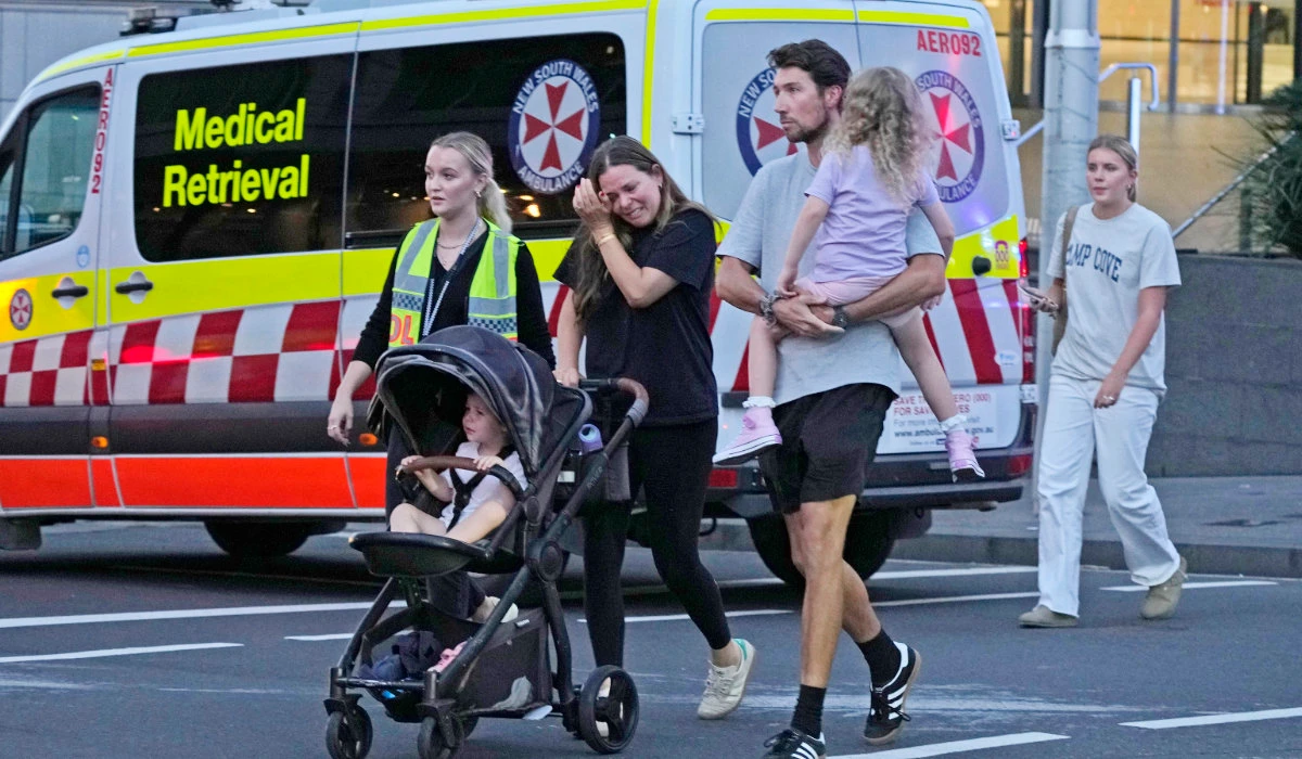 People are led out from the Westfield Shopping Centre where multiple people were stabbed in Sydney, Saturday, April 13, 2024. (AP)