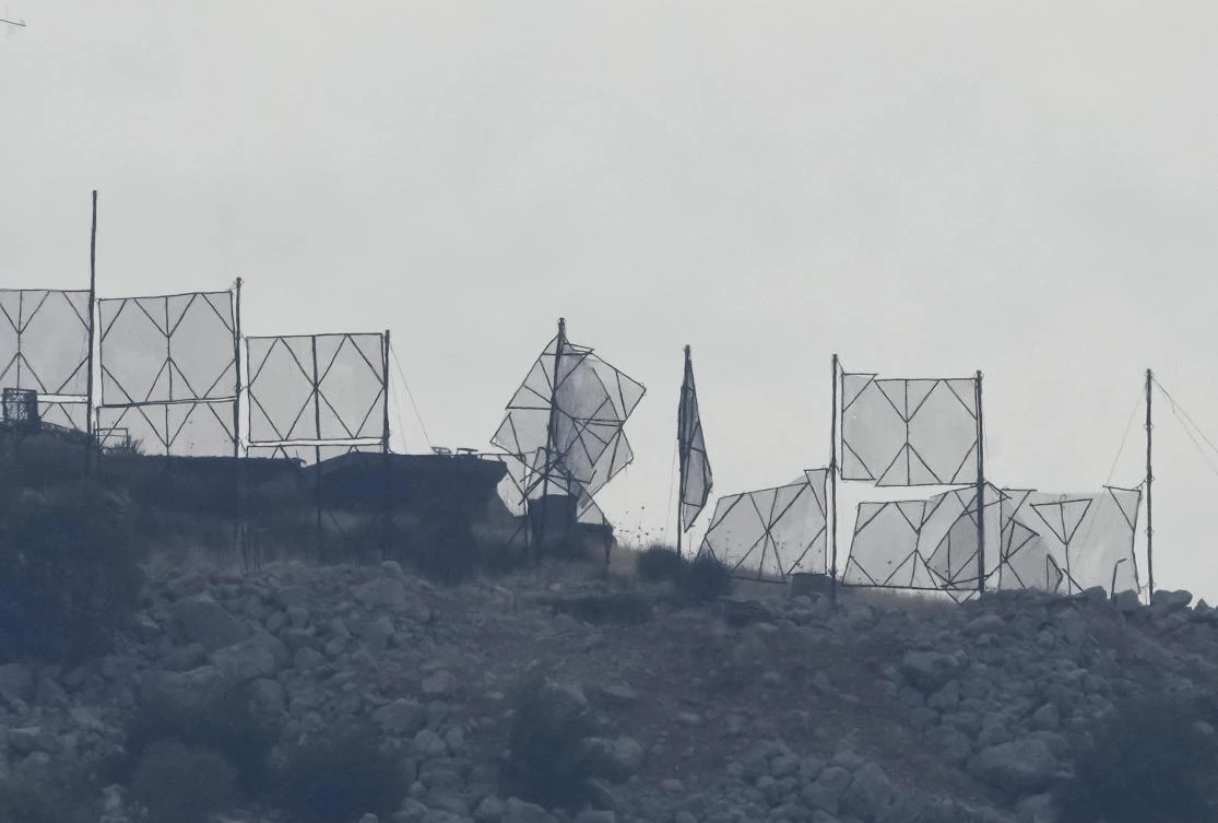 The fence of an Israeli military position is seen damaged after Hezbollah's rocket attacks, on an occupied hill of Kfar Chouba village, southeast Lebanon, Sunday, Oct. 8, 2023. (AP)