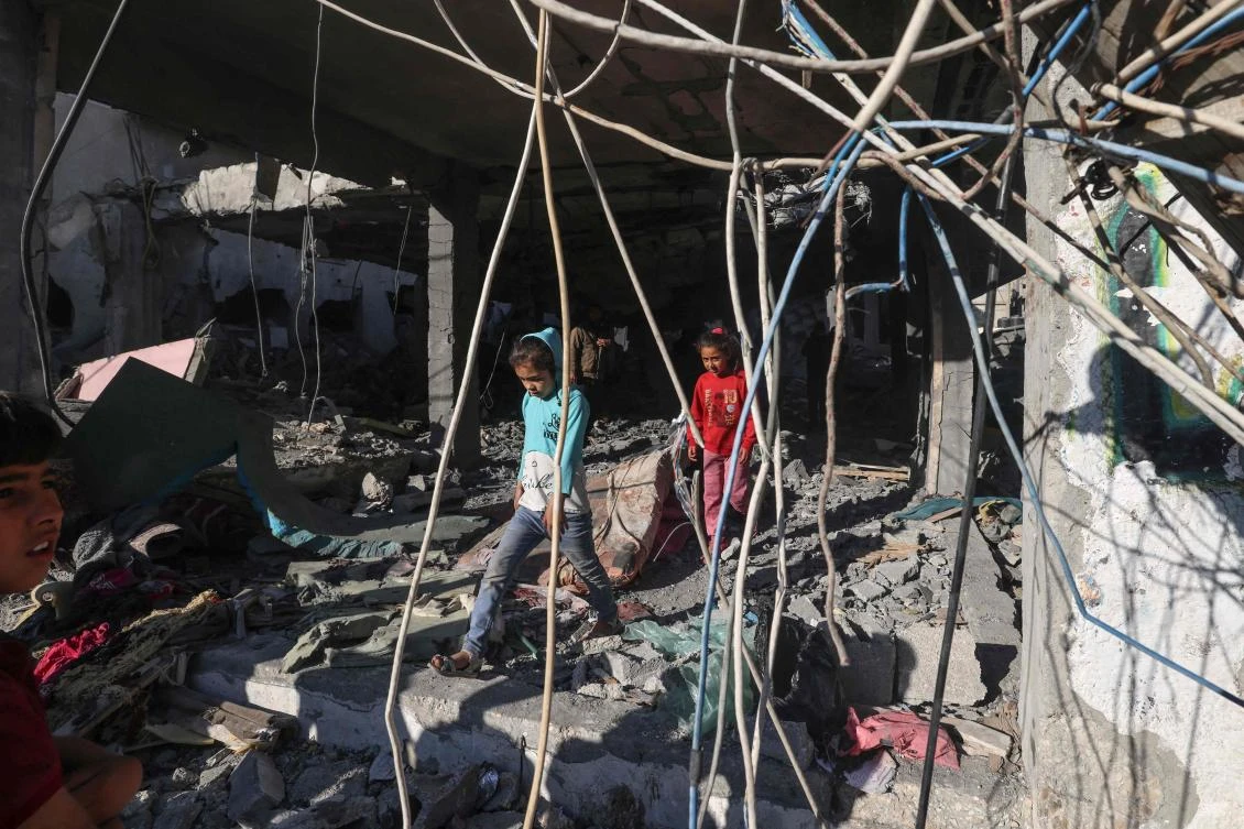Palestinian children check a building destroyed by Israeli bombardment the previous night in Rafah the southern Gaza Strip on April 17, 2024. (AFP)