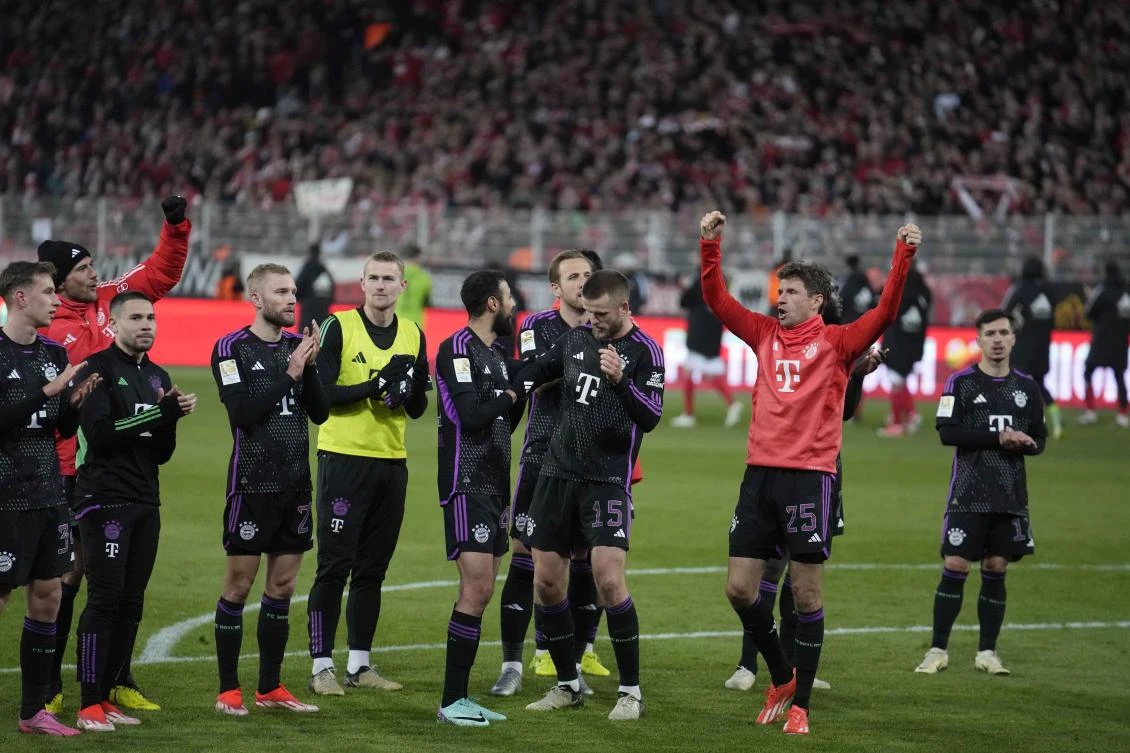 Bayern Munich players celebrate at the end of their Bundesliga match against FC Union Berlin at the An der Alten Forsterei stadium in Berlin on Apr. 20, 2024. (AP)