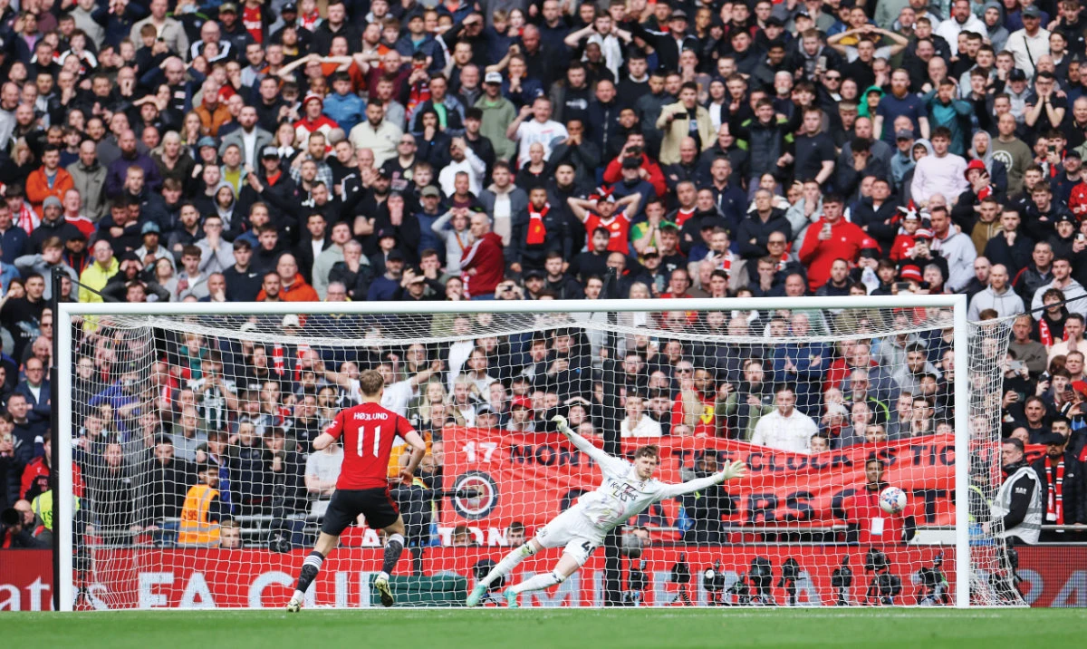 Man United’s Rasmus Hojlund scores the winning goal in the penalty shootout during their match against Coventry at Wembley Stadium in London on Sunday. (Reuters)