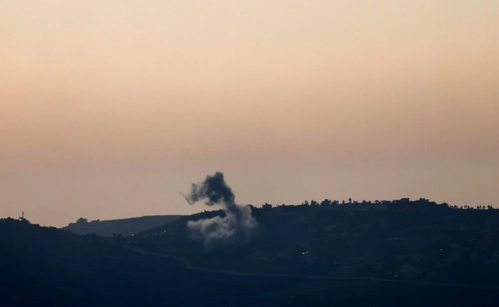 This picture taken from an Israeli position along the border with southern Lebanon shows smoke billowing above the Lebanese village of Odaisseh during Israeli bombardment, Apr. 22, 2024. (AFP)