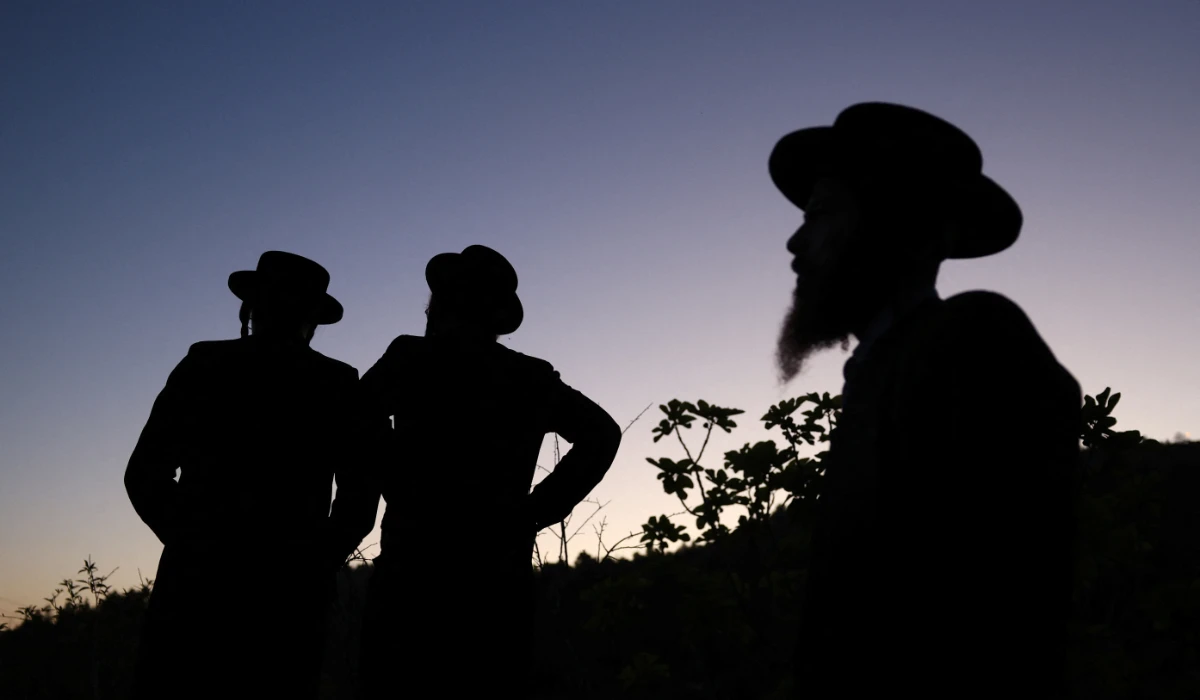 Ultra-Orthodox Jews take part in the "Mayim Shelanu" ceremony in which water is collected from a natural spring for the preparation of matza, the traditional unleavened bread eaten during the upcoming Jewish holiday of Passover, near Jerusalem in the Israeli-occupied West Bank, April 21, 2024. (REUTERS)