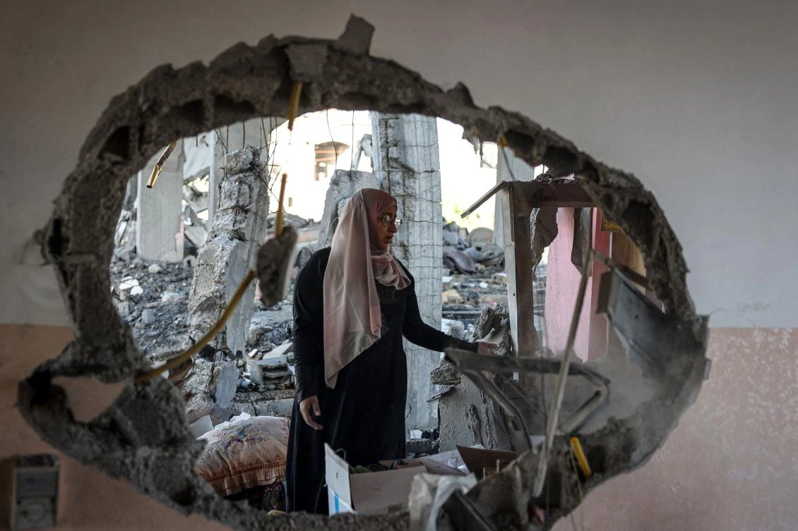A Palestinian woman checks the rubble of a home hit by overnight Israeli bombing in Rafah in the southern Gaza Strip amid the ongoing conflict between Israel and the Hamas movement. (File/AFP)