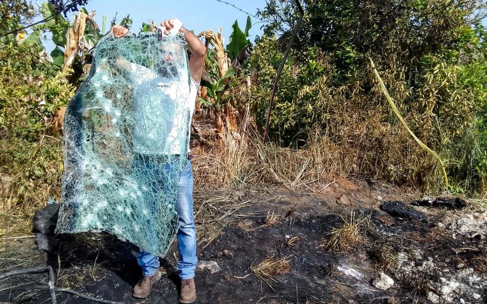 A man inspects the destroyed windshield of a vehicle that was hit by an Israeli strike in the Adloun plain area, between Lebanon’s southern cities of Sidon and Tyre, Apr. 23, 2024. (AFP)