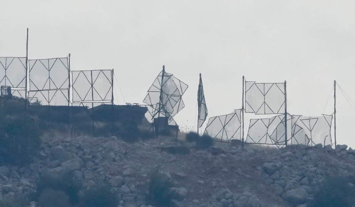 The fence of an Israeli military position is seen damaged after Hezbollah's rocket attacks, on an occupied hill of Kfar Chouba village, southeast Lebanon, Sunday, Oct. 8, 2023. (AP)