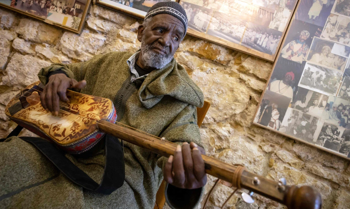 Abdellah El Gourd, a 77-year-old Moroccan legend of gnawa music, poses for a picture in the old city of Tangiers on April 23, 2024. The Moroccan city of Tangiers, which has a long history as a haven of inspiration for American jazz musicians, will host UNESCO's International Jazz Day for the first time on April 30. (AFP)