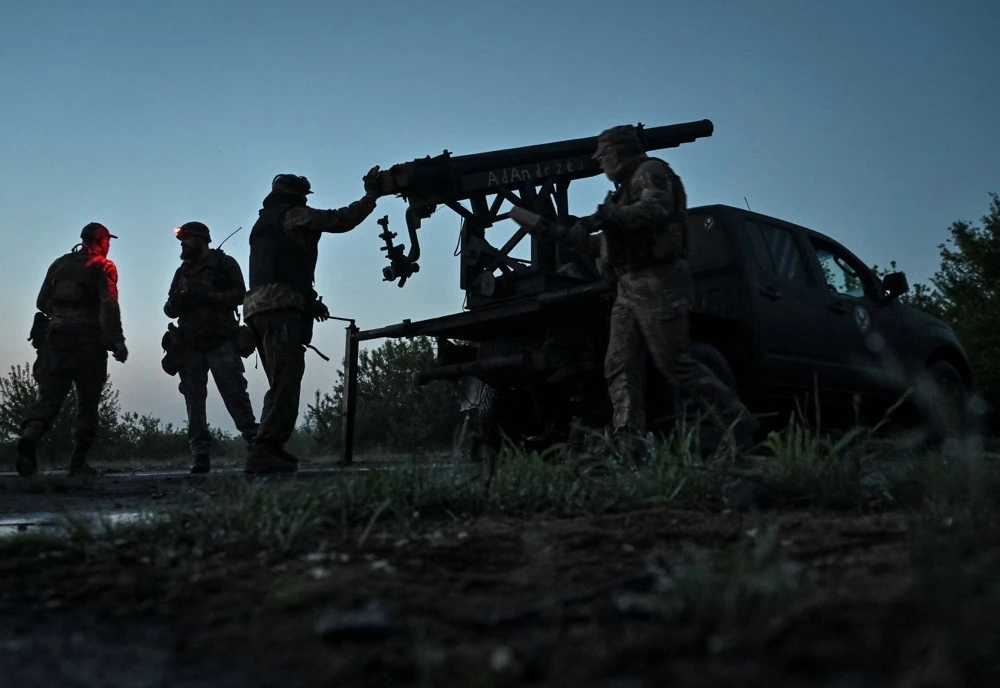 The ‘Steppe Wolves,’ a Voluntary Formation of the Zaporizhzhia Territorial Community prepare a handmade small MLRS. (Reuters)