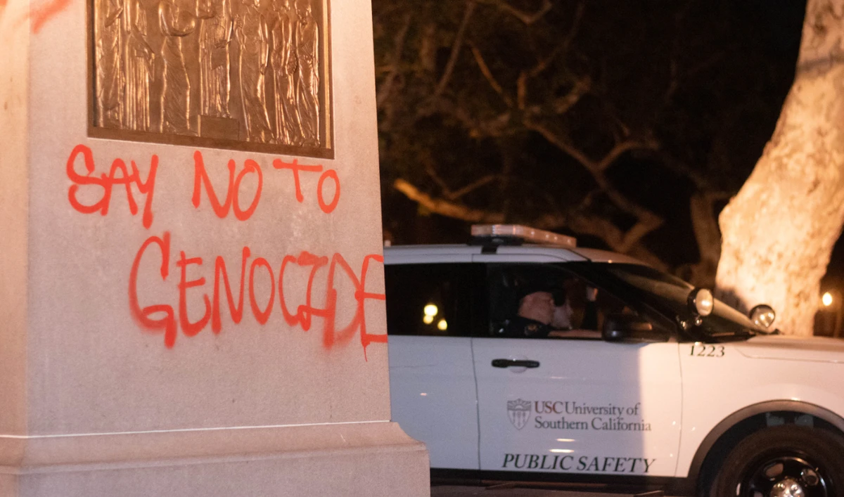 A USC Department of Public Safety vehicle sits next to the base of the Tommy Trojan statue that was tagged in Hahn Plaza at the University of Southern California (USC) in Los Angeles, California, on April 28, 2024. (AFP)