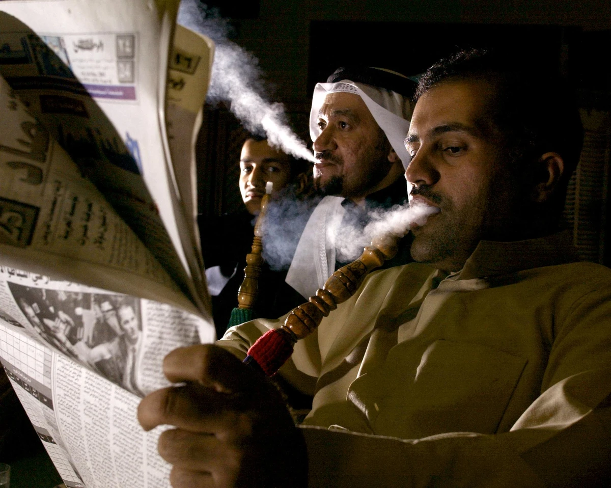 Kuwaitis Abu Mishari (L), Fahad Ghanim(C), and Salah Ghanim(L) have a late night smoke of Shesha. (File/AFP)