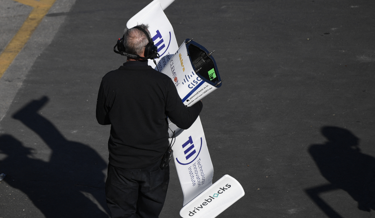 A crew member carries the front nose wing of the KAIST autonomous race car in Las Vegas, Nevada. (AFP)