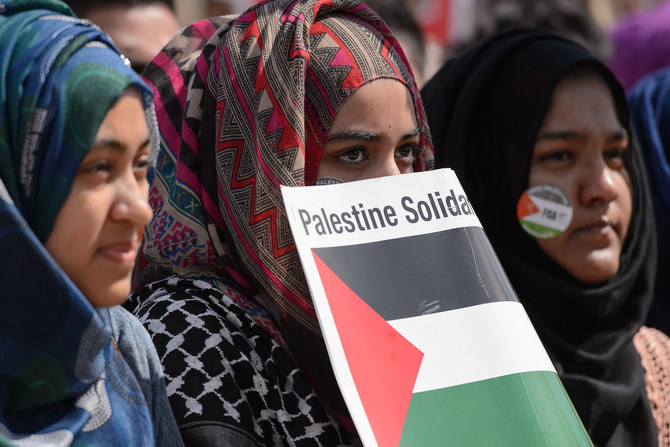 Pro-Palestinian demonstrators wave placards and Palestinian flags at a mass rally in support of Gaza in London. (AFP)