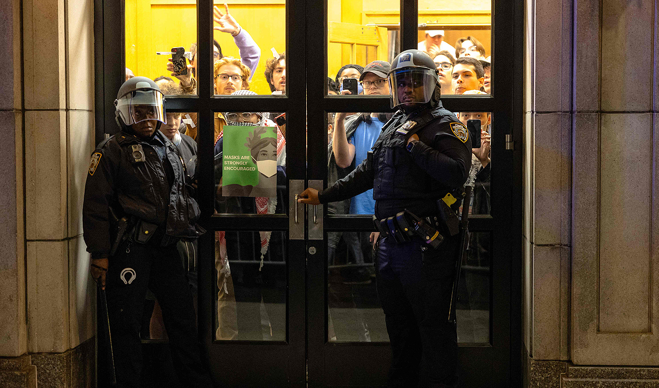 NYPD officers stand watch as they prepare to enter the campus of Columbia University in New York City on April 30, 2024. (AFP)