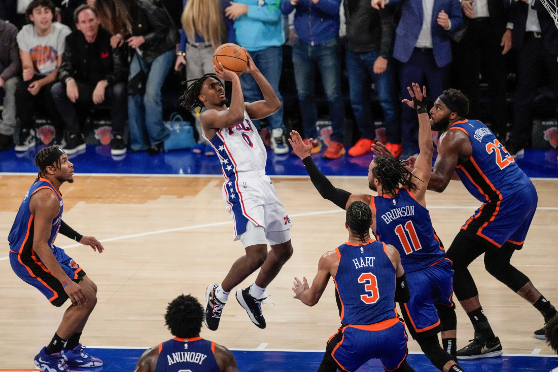 Philadelphia 76ers' Tyrese Maxey shoots over New York Knicks' Jalen Brunson (11), Mitchell Robinson (23) and Josh Hart (3) during the second half of Game 5 in an NBA basketball first-round playoff series in New York. (AP)