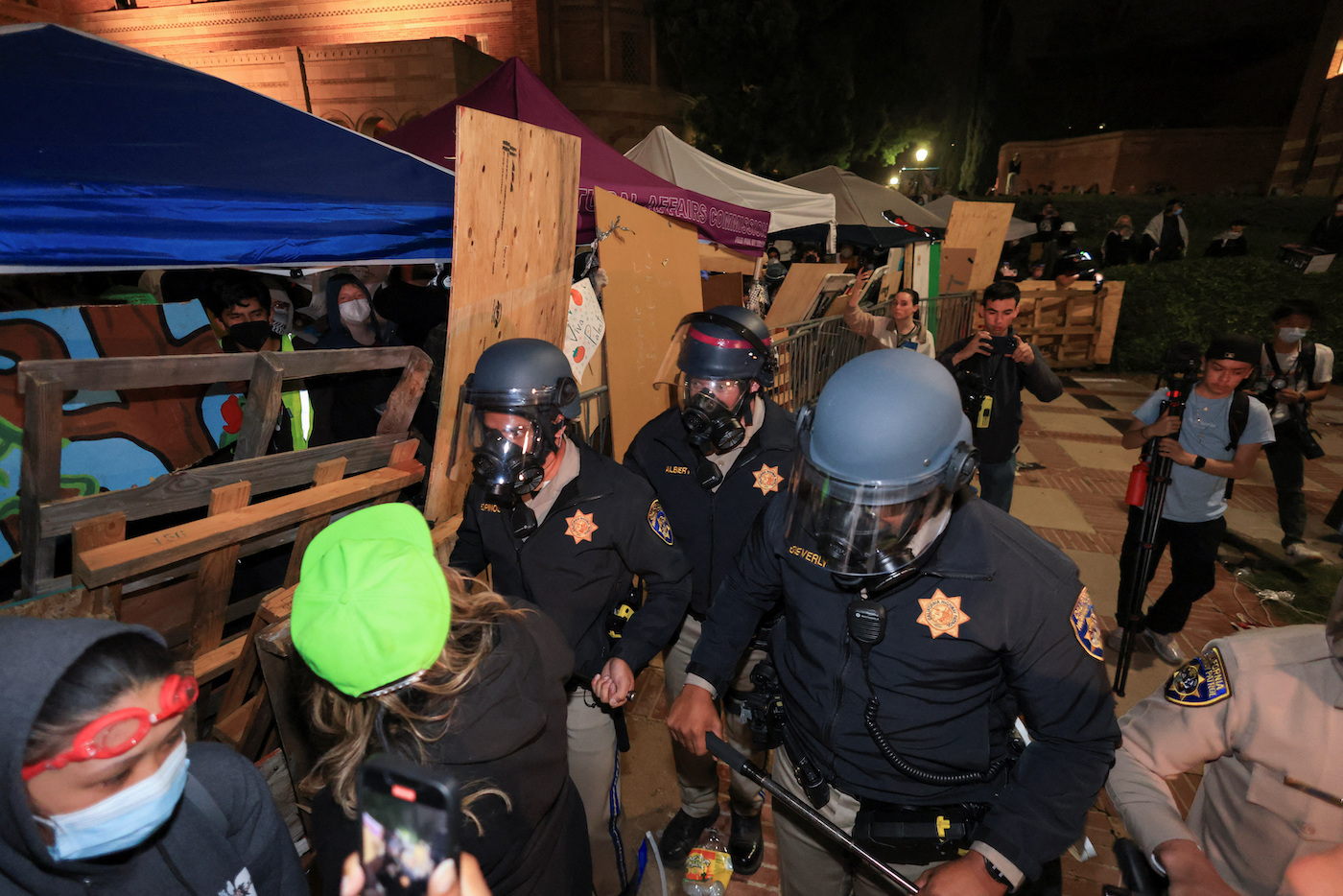 CHP officers walk near an encampment by supporters of Palestinians in Gaza, on the UCLA campus, in Los Angeles, California, US, May 1, 2024. (Reuters)