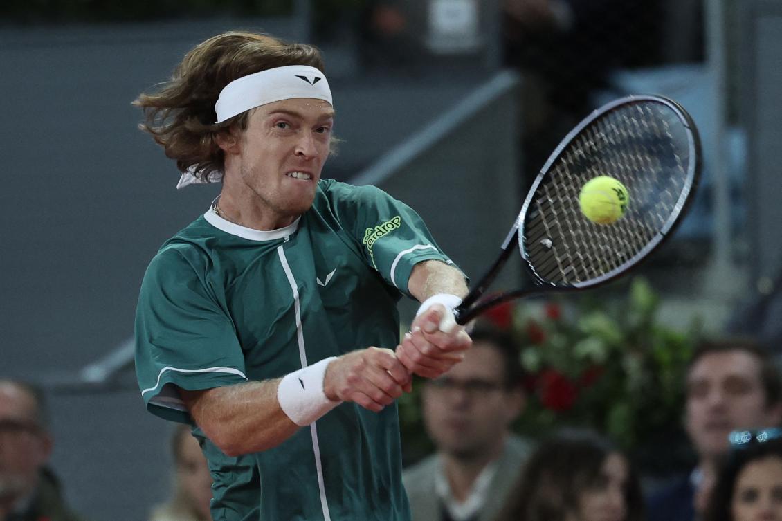 Russia’s Andrey Rublev returns the ball to Spain’s Carlos Alcaraz during the 2024 ATP Tour Madrid Open tournament quarter-final match at Caja Magica in Madrid on May 1, 2024. (AFP)