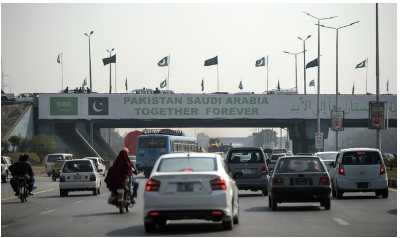 Pakistani commuters drive their vehicles under a banner welcoming Saudi Crown Prince Mohammed bin Salman displayed on a bridge, ahead of his arrival, in Islamabad on Feb.15, 2019. AFP/File