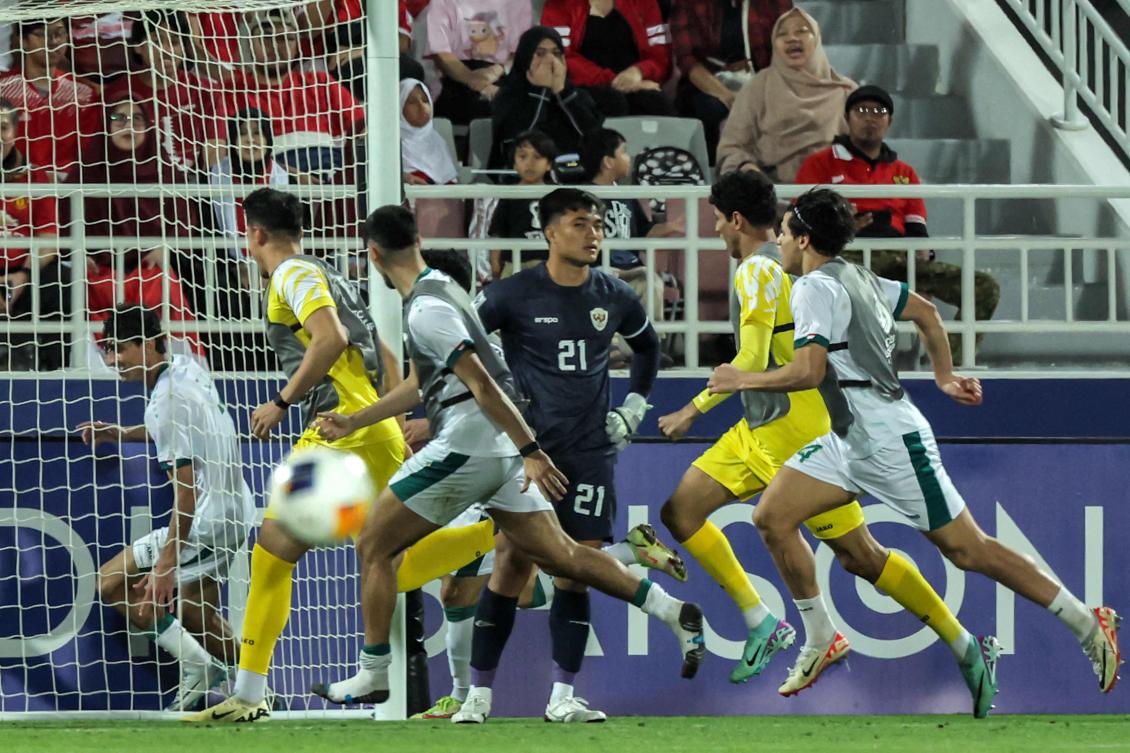 Iraq’s forward Ali Jasim runs behind the net as he celebrates after scoring his team’s second goal during their U23 AFC Qatar 2024 Asian Cup third-place match against Indonesia at Abdullah Bin Khalifa Stadium in Doha on May 2, 2024. (AFP)