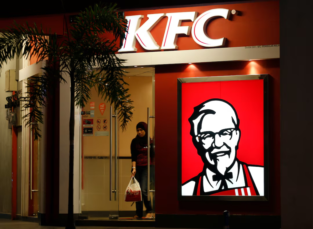 The US-origin fast-food chain has closed more than 100 outlets across Malaysia since October, according to local media estimates. Above, a customer leaves a KFC fast food restaurant in Dengkil, outside Kuala Lumpur on Nov. 3, 2012. (Reuters)