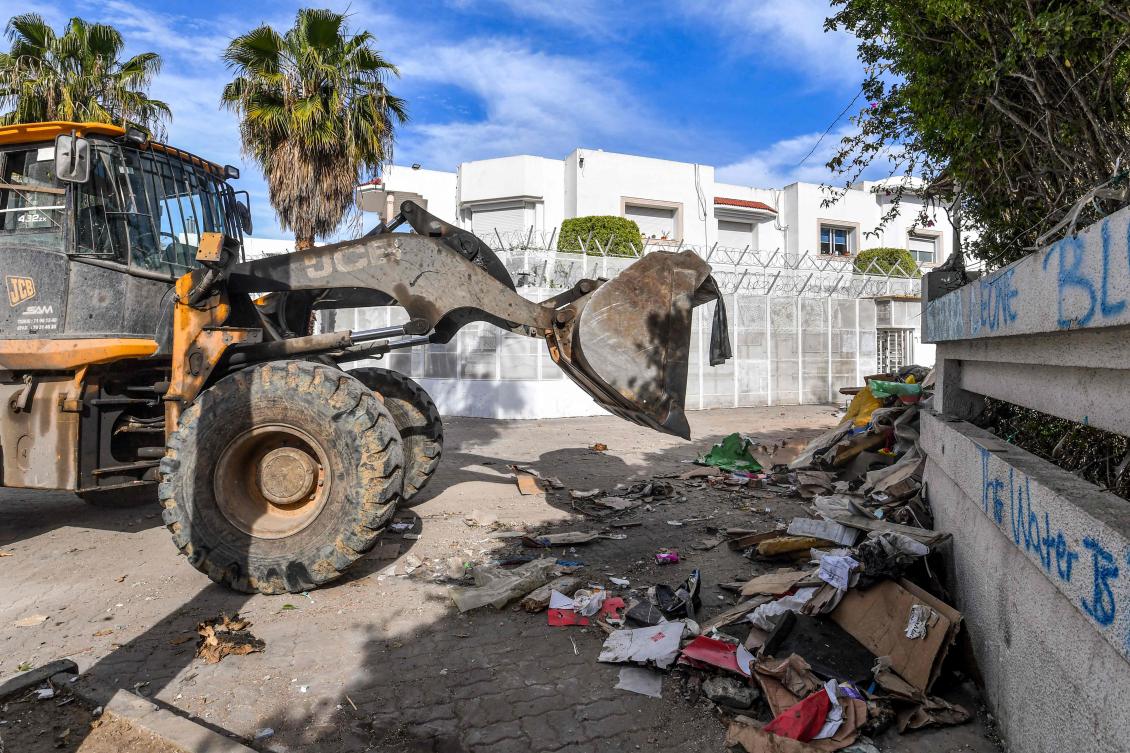 A bulldozer clears debris outside the International Organization for Migration (IOM) headquarters in Tunis on May 3, 2024 after the local authorities removed an encampment that was erected there by migrants in a forced evacuation. (AFP)