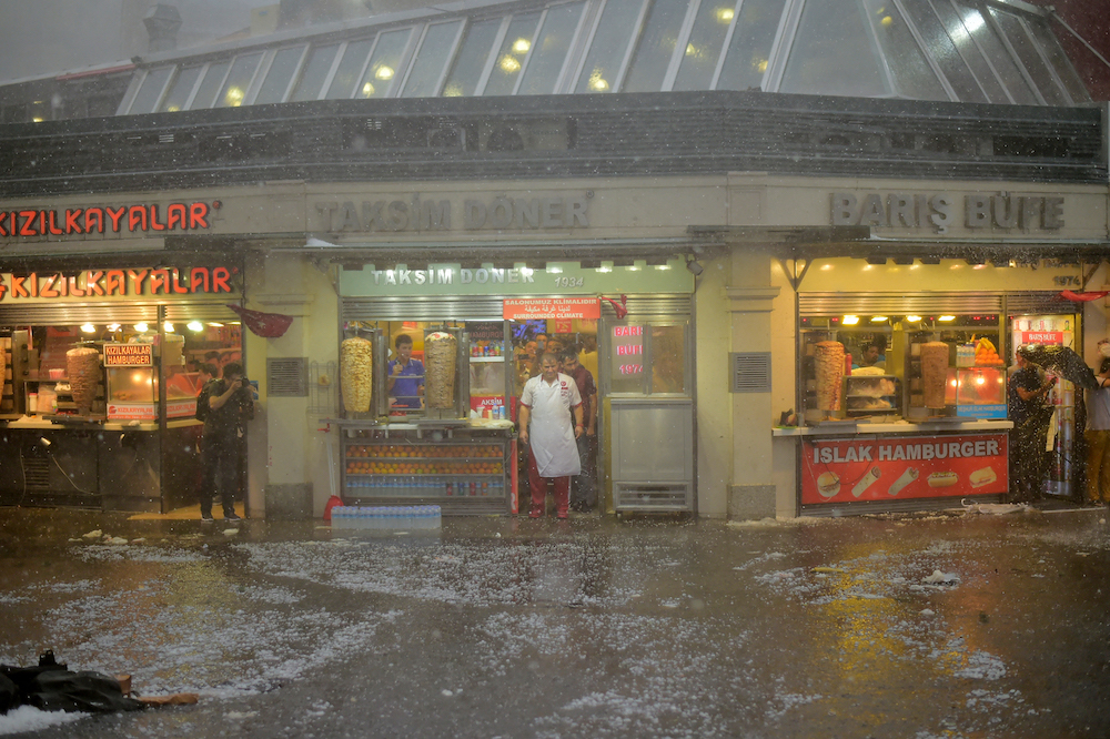 Above, a doner kebab restaurant during a heavy downpour of rain and hail at Taksim in Istanbul on July 27, 2017. (AFP file photo)
