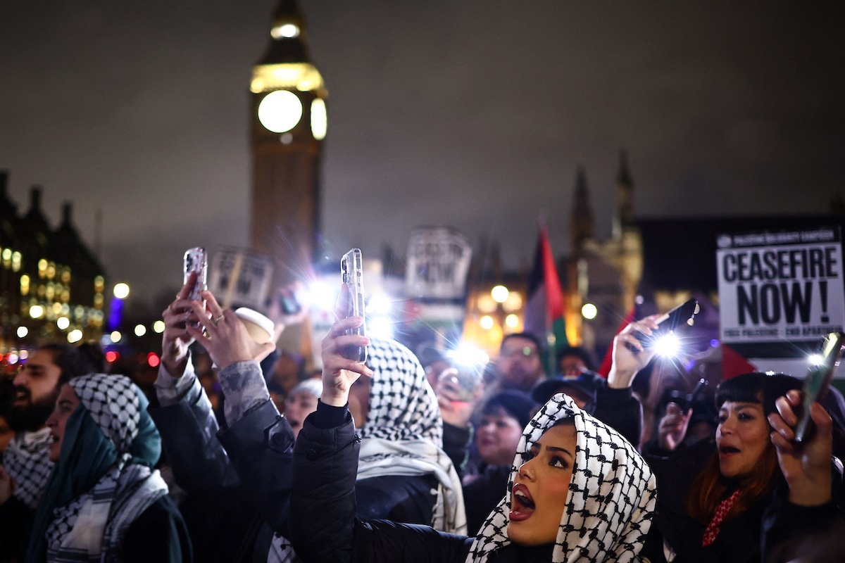 Pro-Palestinian demonstrators wave Palestinian flags and hold placards as they protest in Parliament Square in London on February 21, 2024. (File/AFP)