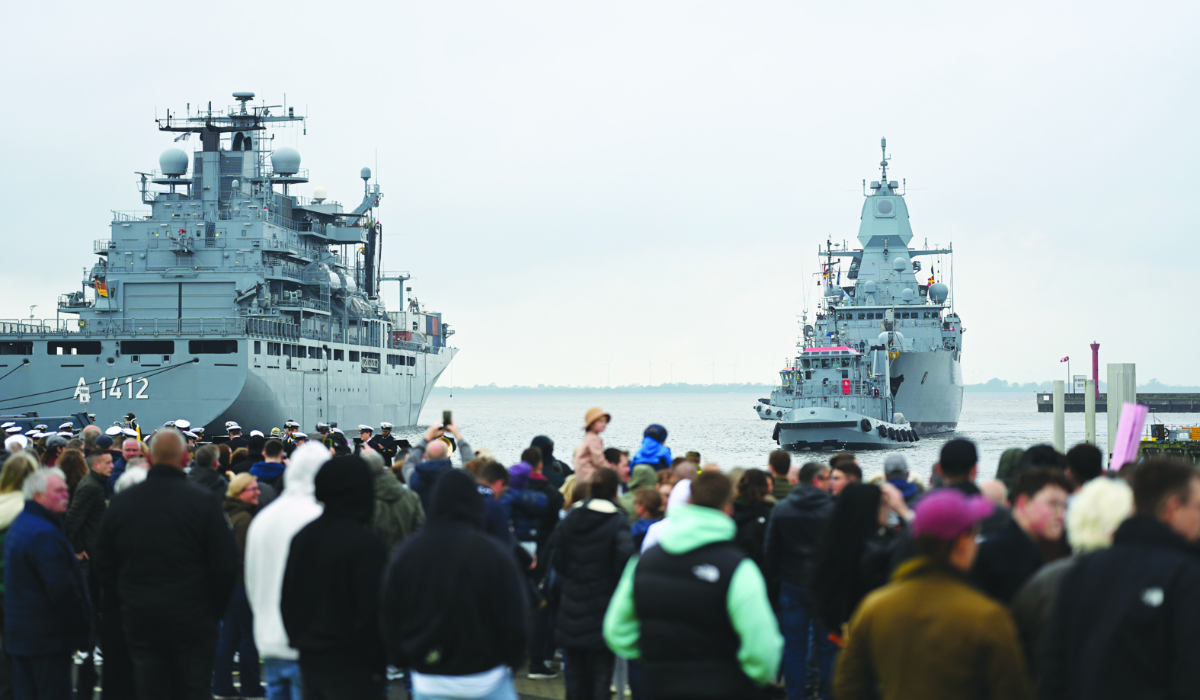 People watch the ‘Hessen’ frigate arriving in the harbor in Wilhelmshaven, Germany. It took part in the EU mission to protect ships from Houthi attacks. (AP)