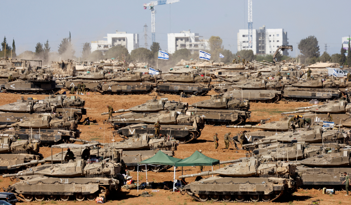 Israeli soldiers stand next to military vehicles, amid the ongoing conflict between Israel and the Palestinian Islamist group Hamas, near the Israel-Gaza Border, in southern Israel, May 7, 2024. (REUTERS)