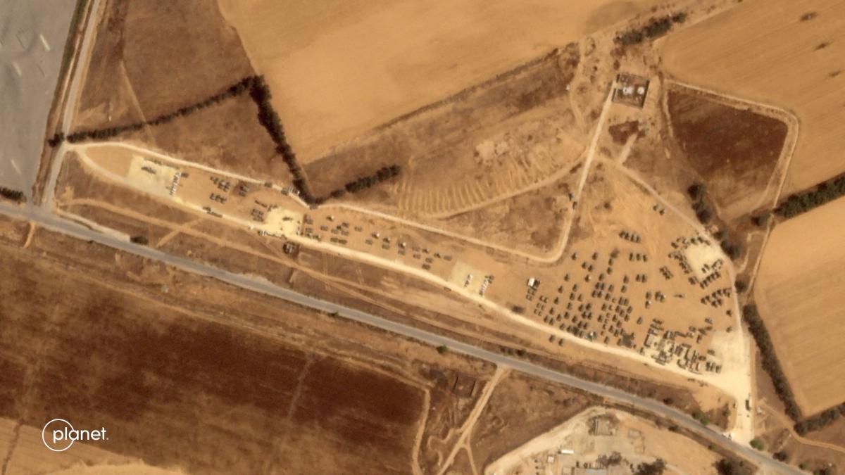 Above, a Planet Labs PBC satellite picture on May 3, 2024 shows Israeli military vehicles massing up in area near the Kerem Shalom border crossing with the Gaza Strip. (Planet Labs PBC/AFP)