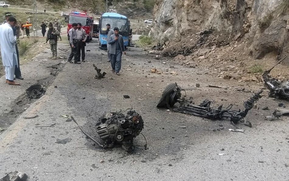 Police officers examine the site of an attack on Chinese nationals at a highway in Shangla district in Pakistan’s Khyber Pakhtunkhwa province, March 26, 2024. (AP Photo)