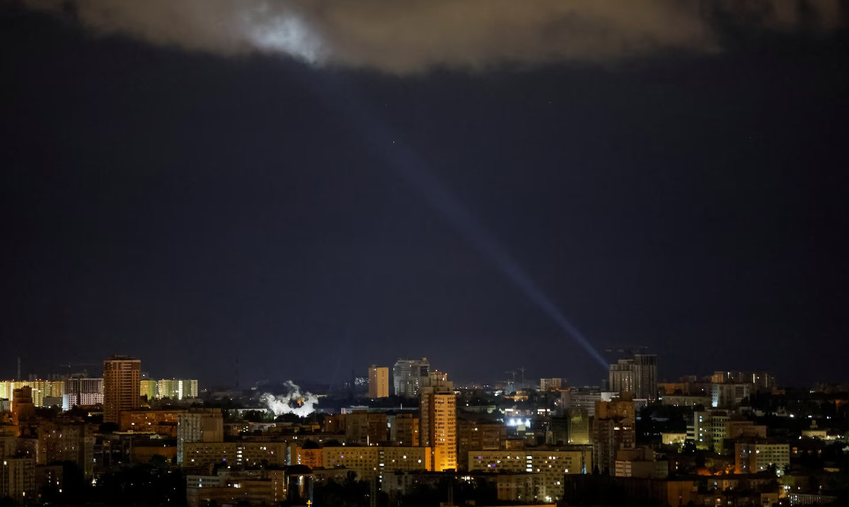 Ukrainian servicemen use a searchlight as they search for drones in the sky over the city during a Russian drone and missile strike in Kyiv, Ukraine May 8, 2024. (Reuters)