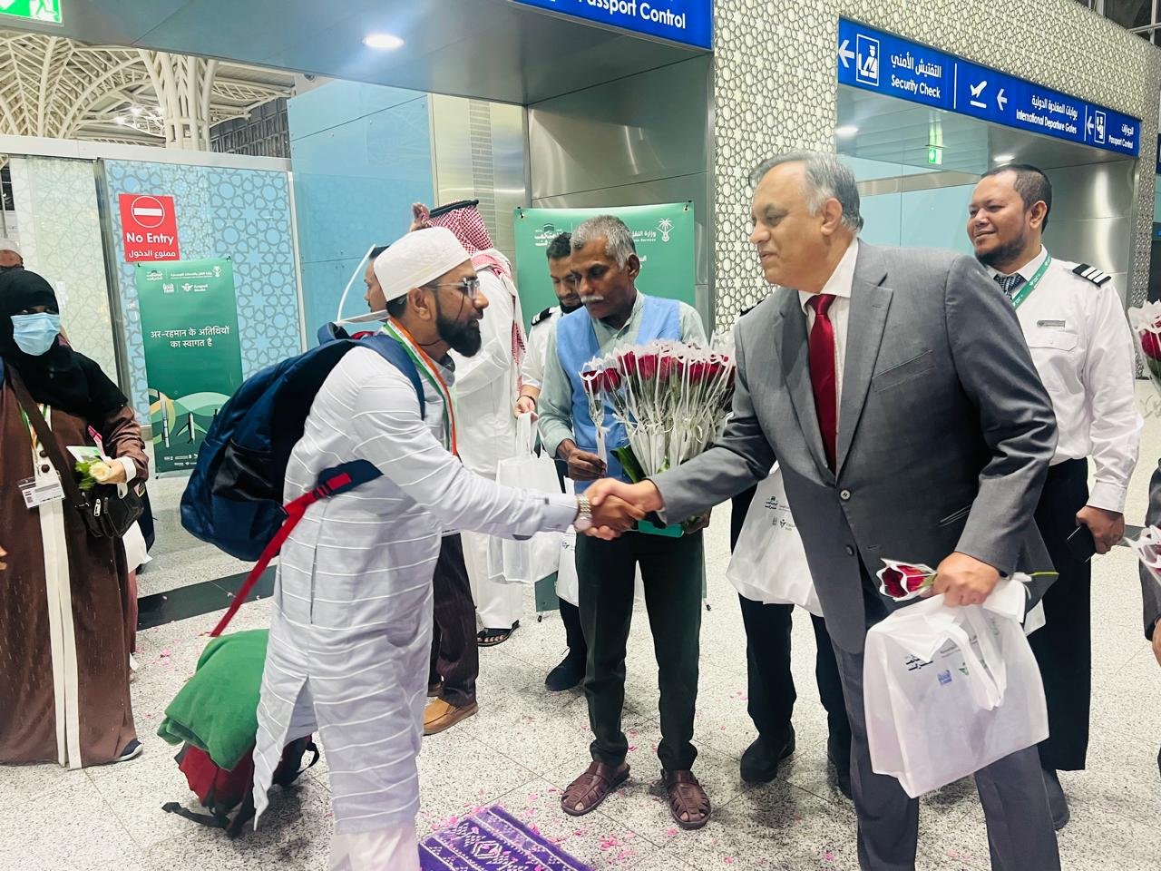 Indian Ambassador to Saudi Arabia Suhel Ajaz Khan, right, shakes hands with an arriving pilgrim from the South Asian country in Madinah. (Indian Haj Mission)