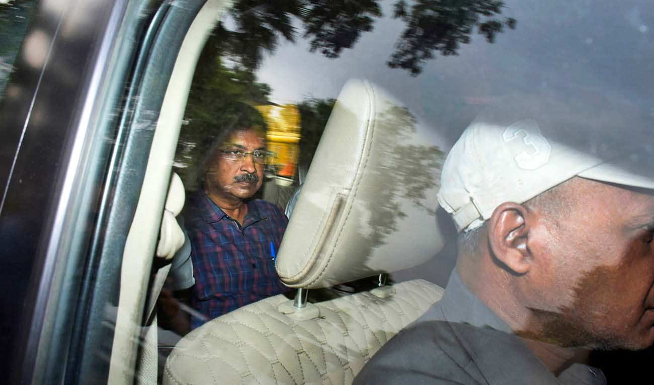 Arvind Kejriwal, leader of the Aam Admi Party, or Common Man's Party, left, leaves in a car after a court extended his custody for four more days, in New Delhi, India, March 28, 2024. India's top court on Friday gave interim bail to the top opposition leader who was arrested nearly seven weeks ago. (AFP/File)