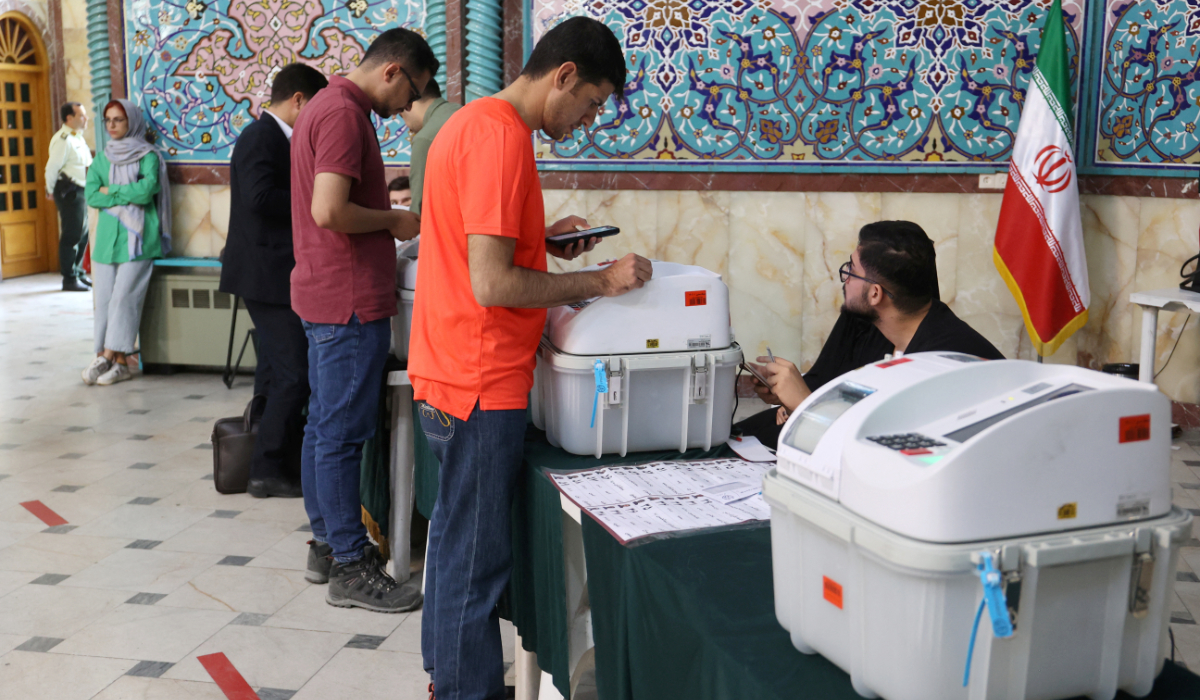 People vote during Friday’s runoff parliamentary elections in Tehran. (Reuters)