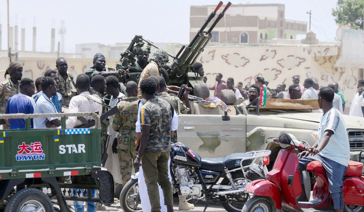 Sudanese greet army soldiers, loyal to army chief Abdel Fattah al-Burhan, in the Red Sea city of Port Sudan on April 16, 2023. (AFP)
