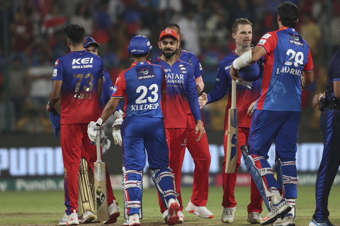 Royal Challengers Bengaluru’s Virat Kohli, center, greets Delhi Capitals players after they won the IPL match against Delhi Capitals in Bengaluru. (AP)