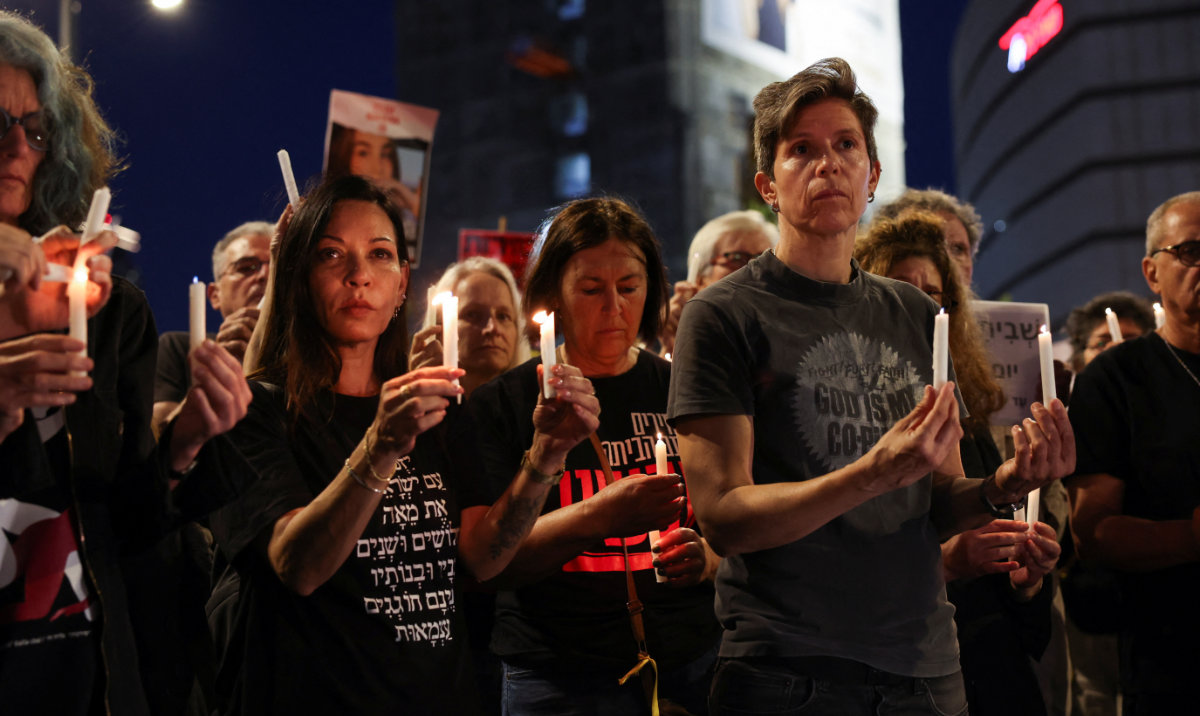 People stand still, on the day a siren sounds marking Israel's Memorial Day, when the country commemorates fallen soldiers of Israel's wars and Israeli victims of hostile attacks, amid the ongoing conflict in Gaza between Israel and the Palestinian Islamist group Hamas, in Tel Aviv, Israel May 12, 2024. (Reuters)
