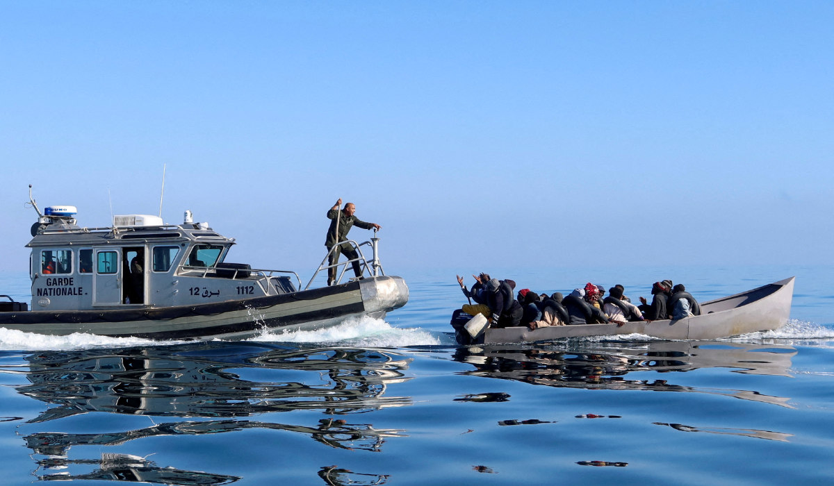 Tunisian coast guards try to stop migrants at sea during their attempt to cross to Italy, off the coast off Sfax, Tunisia April 27, 2023. (REUTERS)