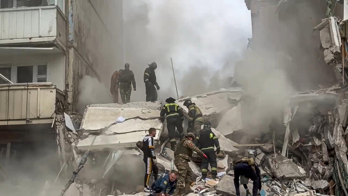 Russian emergency service employees work at the scene of a partially collapsed block of flats after a Ukrainian missile attack in Belgorod. (Belgorod region governor Vyacheslav Gladkov Telegram channel via AP)