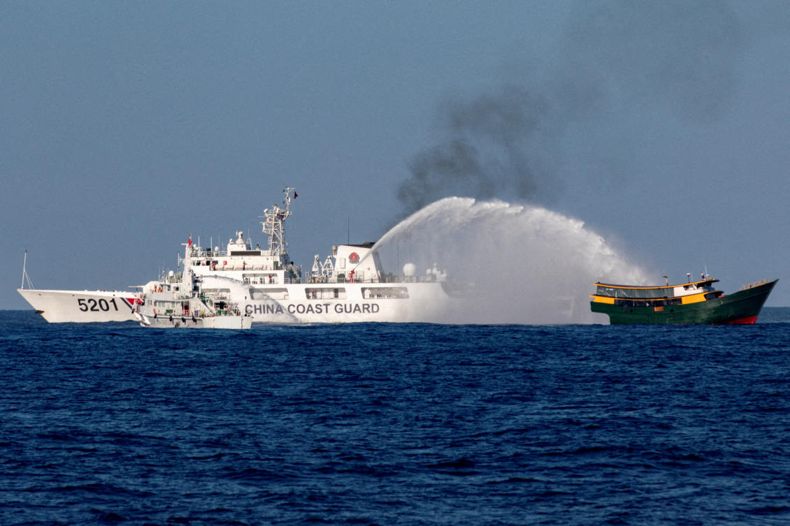 Chinese Coast Guard vessels fire water cannons toward a Philippine resupply vessel Unaizah on May 4 as it made its way to the Second Thomas Shoal in the South China Sea on March 5, 2024. (Reuters)