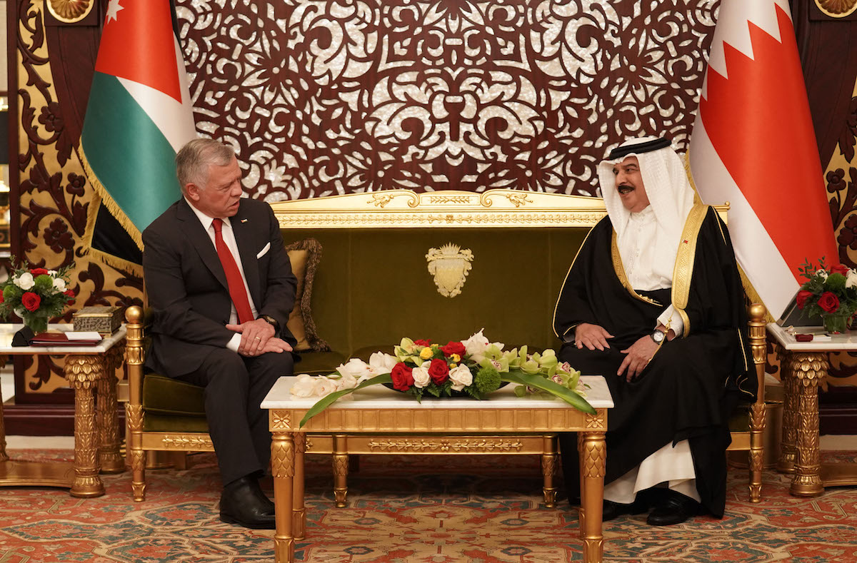 A handout picture released by the Jordanian Royal Palace on November 22, 2021 Jordan's King Abdullah II (L) meeting with Bahrain's King Hamad bin Isa al-Khalifa upon his arrival at the Sakhir Air Base. (File/AFP)